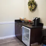 Interior photo: St James NY Dental waiting room amenities: cold water, snacks, and coffee