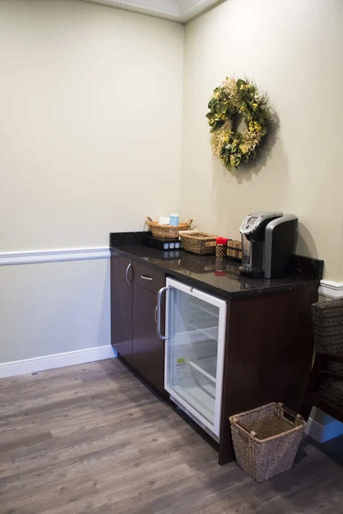 Interior photo: St James NY Dental waiting room amenities: cold water, snacks, and coffee